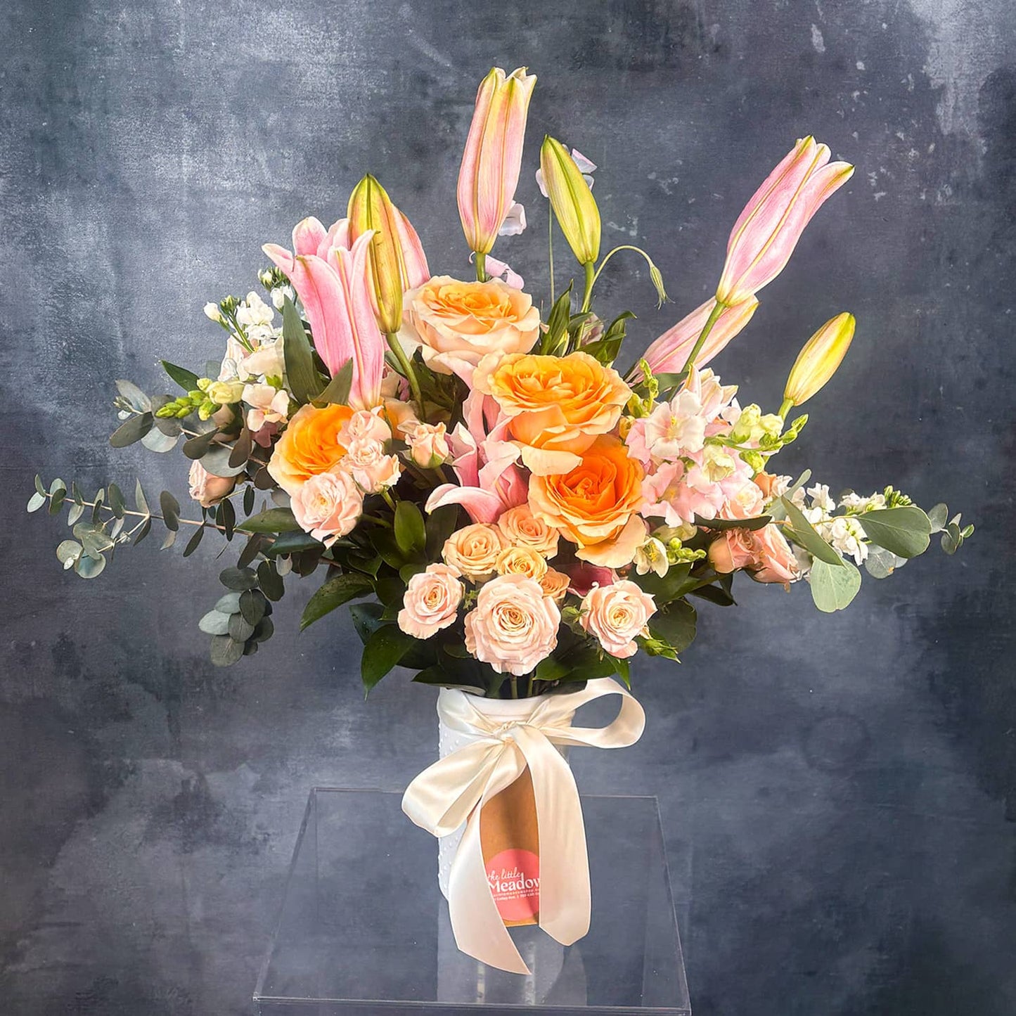 Bouquet of flowers with pink, orange, and green colors on a dark background