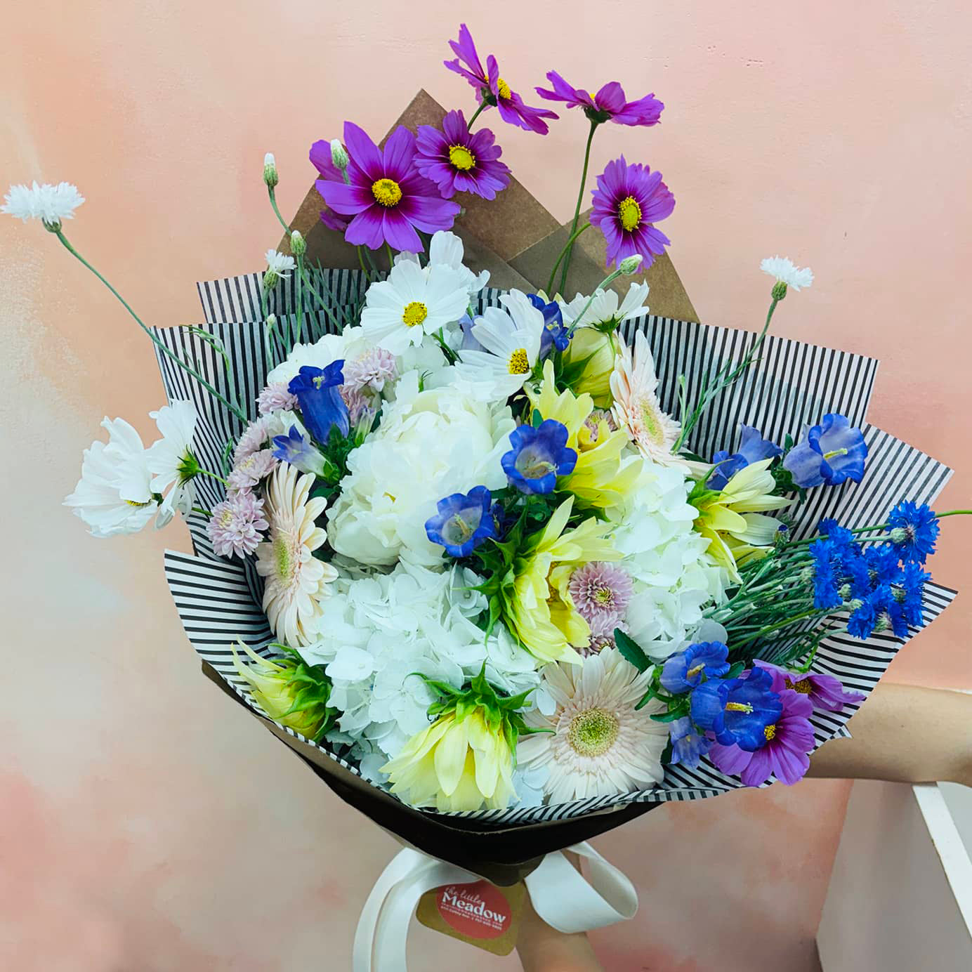 Bouquet of flowers with white, purple, and blue colors on a blurred background